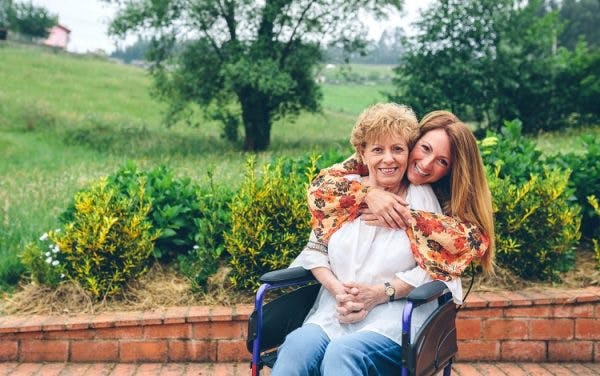 woman overcoming psychological effects of spinal cord injury with support of daughter