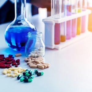 various vitamins for cerebral palsy arranged on a lab table with test tubes in the background