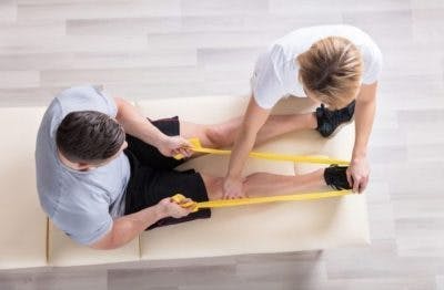 thérapeute travaillant avec le patient pour réparer les orteils enroulés avec des exercices
